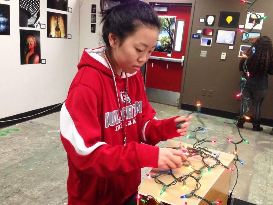 Kimoto adding festive lights to one of her art projects.