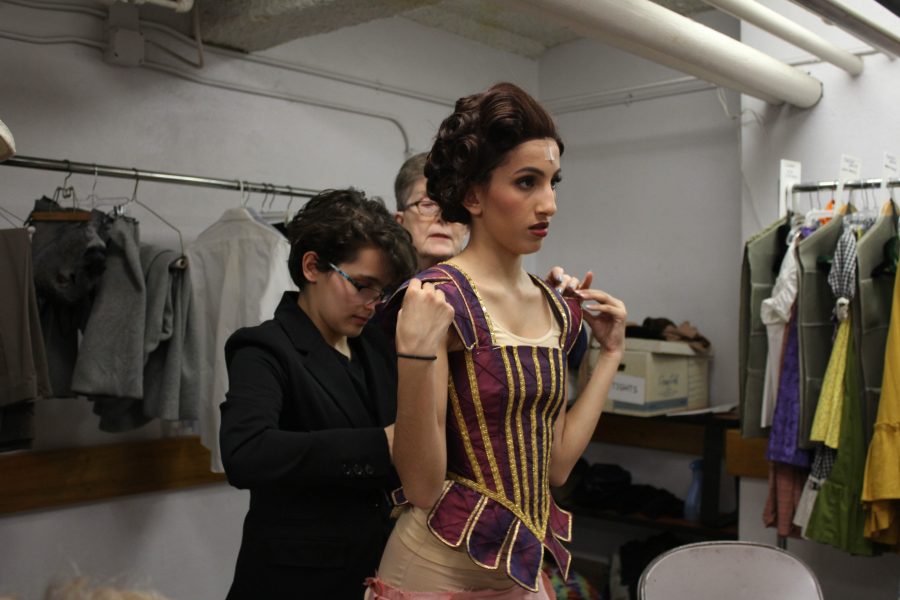 Phoebe Rodriguez adjusts the corset on Janine Lutfis dress. Photo by Melanie Pinzon. 
