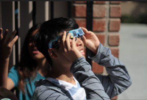 Senior Bill Chen watches the solar eclipse. Photo by Camille Salud.