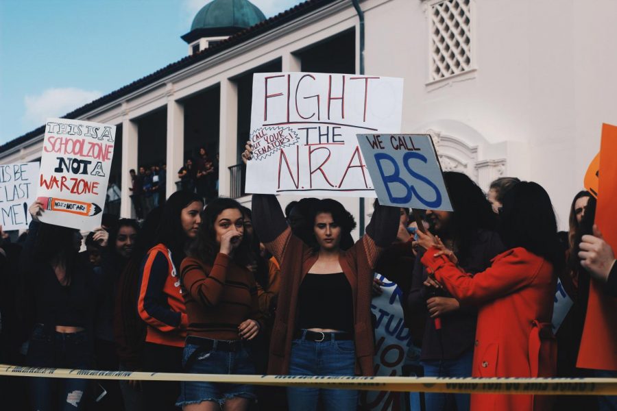 Students hold up signs, speaking out against gun violence. Photo by Anthony Rugama.