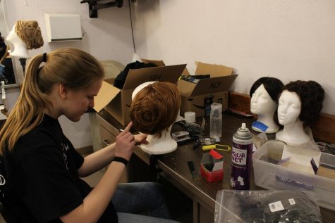 Olvia Kehoe works on the wigs for the show. Photo by Melanie Pinzon