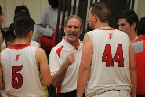 Coach Scott Sinek coaches his team during a timeout. Photo creds: Kylen Campbell