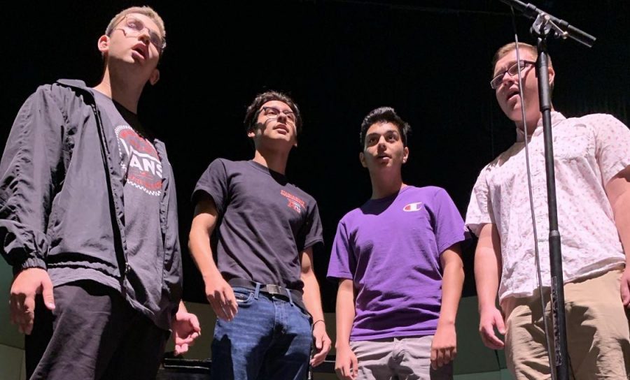 The barbershop quartet Nothing Rhymes with Orange will sing “Can You Feel the Love Tonight” from the Disney film The Lion King. In order from left to right, junior Ryan Simpson, and seniors Elias Beltran, Elijah Brandquist, Cooper Miller rehearse for tonight’s concert. Photo by Jeanmarco Flores.