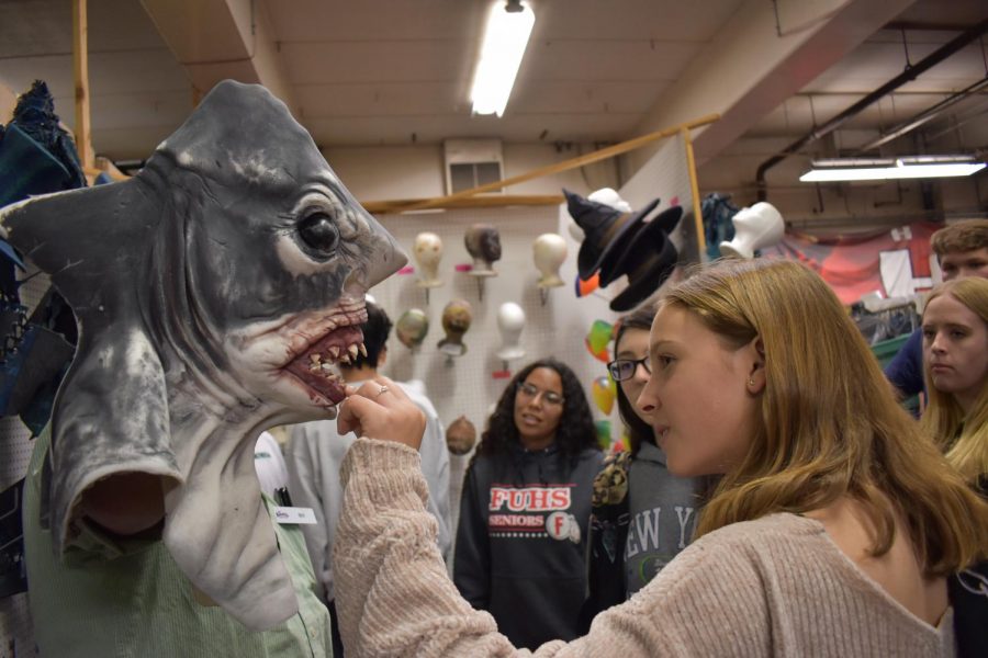 Sophomore Maggie Kelly feels a shark mask used during Knott’s Scary Farm events. Photo by Lauren Wright.