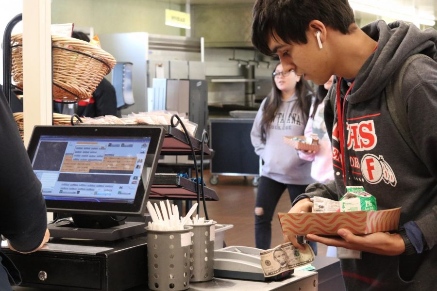 Senior Phillip Fisher enters his ID number to pay for lunch. Photo by Betsy Barreto.