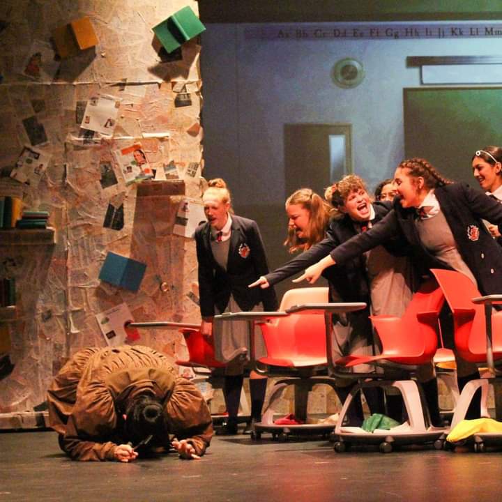 A crushing heartbreak for the theater department was the March 13 cancelation of Matilda. Junior Nate Baesel is on the floor while (from left) Madeline Lange, Haley Cronin, Ryder Tucker, and Allie Jeha play their roles as bullying school children. Ryder said that locking down right before opening night was hard for freshmen who were just gaining momentum in theater arts. Photo courtesy of Ryder Tucker.