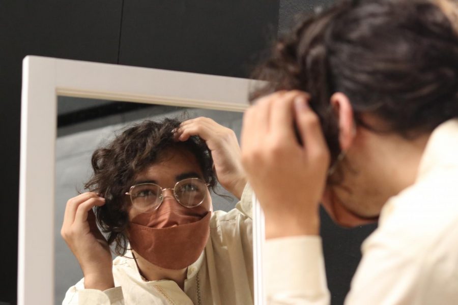 Although cast members, including senior Tari Cuevas, wear masks during the show, the audience soon forgets about COVID protocols once the play begins.