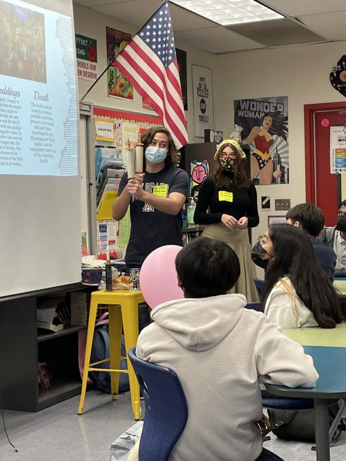 OC Student to Student members Ian Klatzker and Alex Winnik give a presentation in English teacher Melissa Galvan’s 8th grade English class at Oxford Academy in Cypress. Galvan’s class was preparing to read the play version of The Diary of Anne Frank. FUHS Junior Klatzer (left) holds up a miniature Torah scroll.