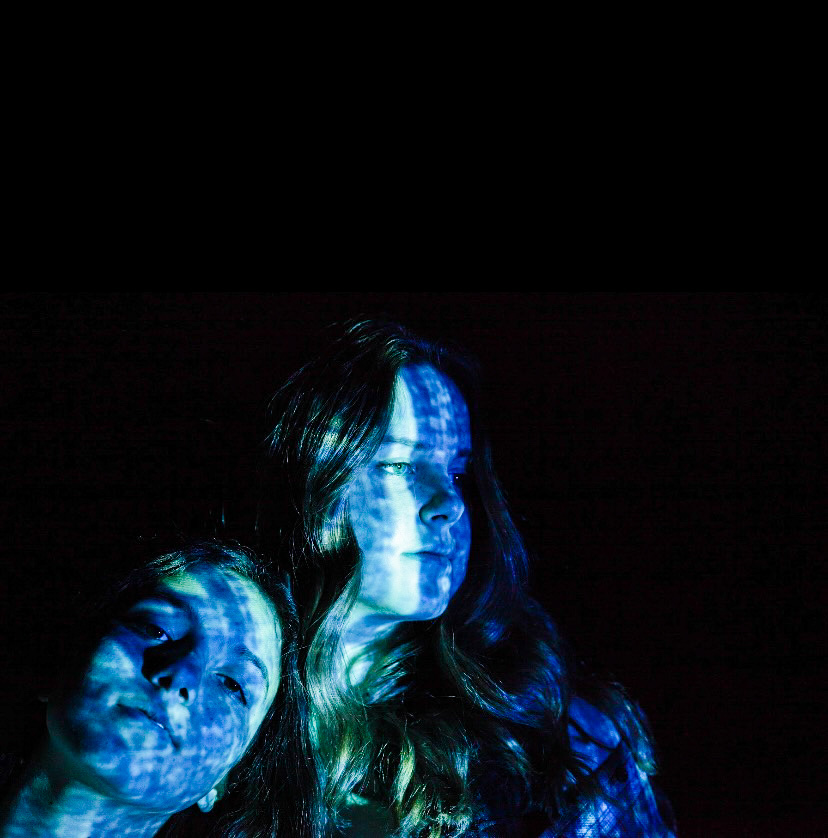 Spillane took a photo outside at night and used a projector to display images on her models’ faces. Showing that the digital world can bring closeness to relationships.After trying several images including a display of binary 0-1-0-1 code, Spillane settled on the blue tones that suggest the glow of a computer monitor.“It’s kind of hard to take photos of something online, so this is trying to show an online or digital connection with the two people even though here they appear in the same space,” Spillane said.