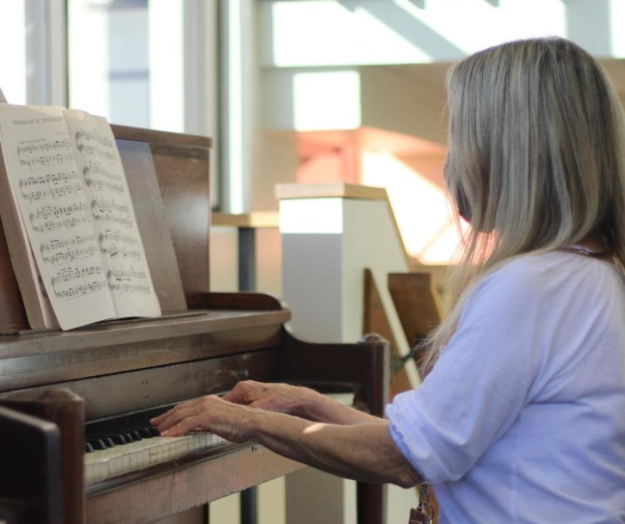 Jean Page accepted pianos from Troy Trimble to place in the library to create a more recreational setting.