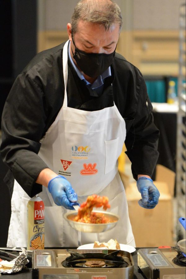 Chef Mario Schwarz-Cole prepares his original dish Chicken Kashmir for the baked potato topping event at the Prostart Cup Challenge. His recipe included grilled chicken, red pepper, garbanzo in tomato curry sauce topped with brown butter potatoes and shoestring tortilla.
