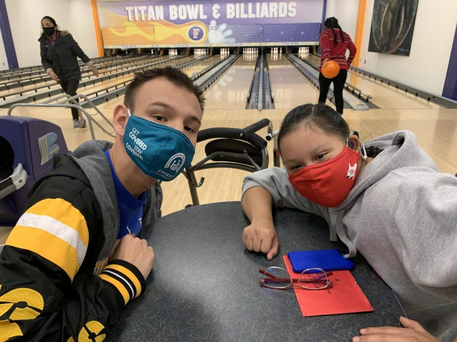 Students Evan Tallant and Bella Arriaga enjoy ATP Christmas Bowling party at the CSUF bowling alley after successful donation collection for Ally’s Rescue.