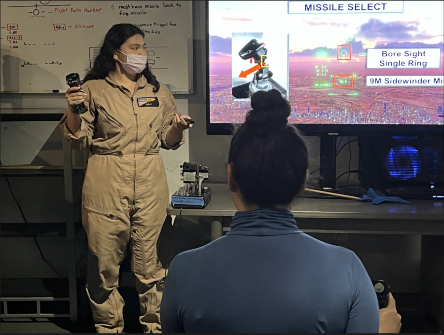 Hannah Ramos briefs customers on how to fly the simulation before leading them to the cockpits. 