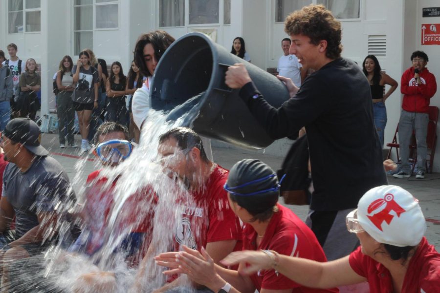 In addition to homecoming, ASB worked hard the week before homecoming by hosting a Soak-A-Teacher fundraiser. Seniors Noah Hernandez and Josiah Reed work together to dump a trashcan full of water on basketball Coach Kamrath.