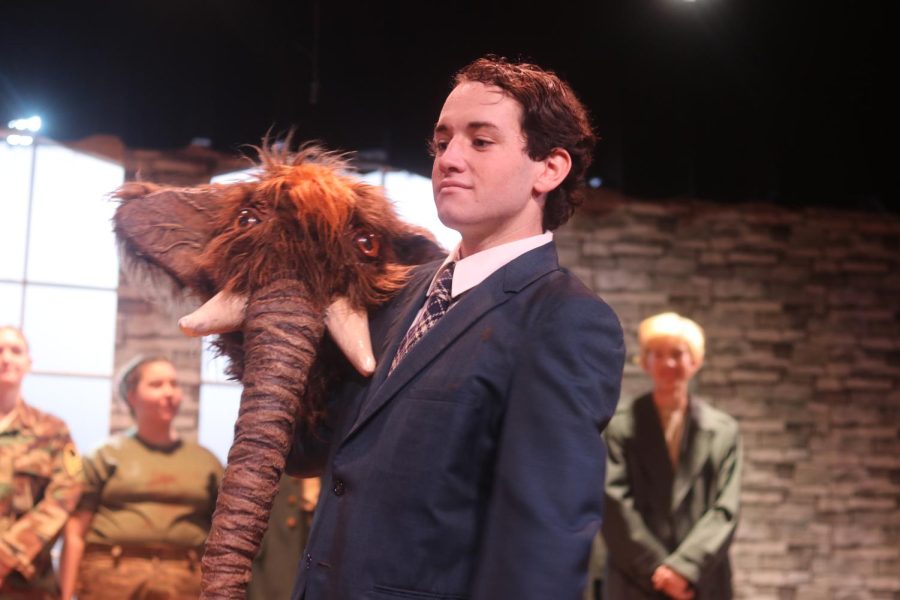 Senior Marco LaRosa, playing both the Announcer and the Wooly Mammoth, bows. BEAST students created the mask and matching mammoth feet, which LaRosa wears during the play.