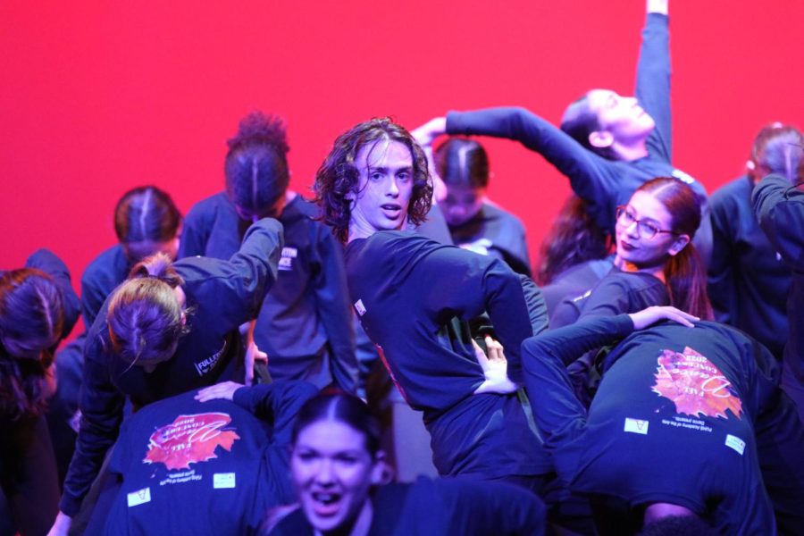 Senior Cole Thomson strikes a pose during the finale at the fall dance concert.