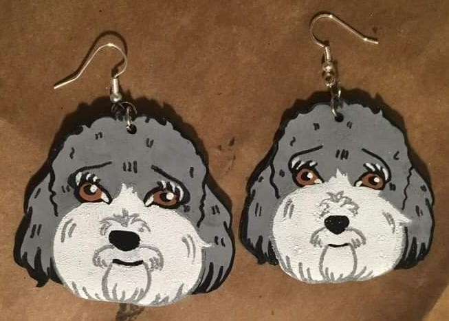 Earrings of her dog, Cooper, made by Galvan.