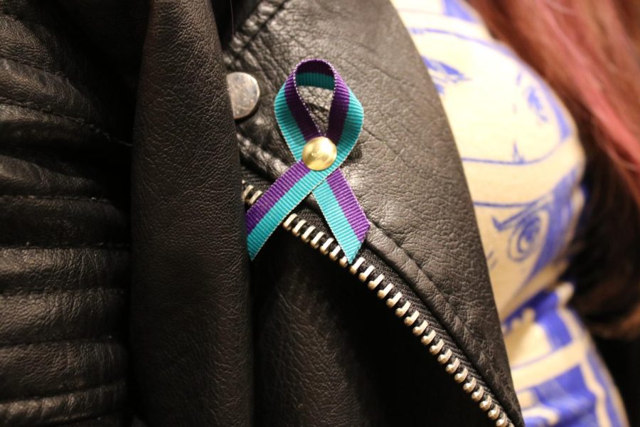 Workshop organizers distributed suicide prevention pins, highlighting the connection between drug use and mental health.
