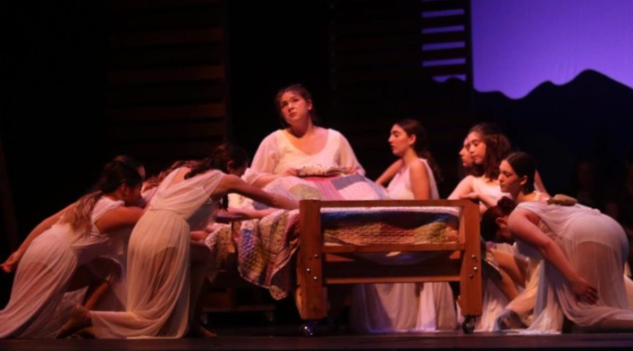Mama Cane is wheeled in on a hand-made bed by spirit ensemble dancers at the beginning of “She’s Gone.”