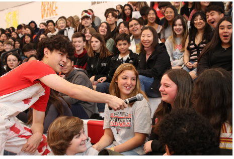 ASB vice president Rowan Yeo asks an eighth grader why she’s wearing a Troy sweatshirt at a Fullerton High School visitation day. Ladera Vista Junior High School of the Arts and Beechwood School students visited the FUHS campus Nov. 30 to preview campus programs including Cheer, Dance Production, Speech and Debate, Theatre, Jazz Band and many more. (Photo by Jonathan Pina-Villanueva)