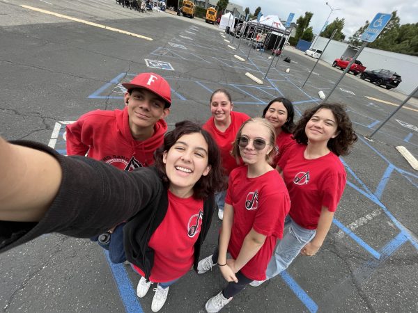 Evelyn takes a picture with her flute section during a marching band clinic. From left to right, junior Devyn Jacobo, senior Hannah Day, freshman Emily Ito, freshman Katelyn Rodriguez, and freshman Audrey Chappell. After two years from having about 2-3 flute players Evelyn feels exceedingly happy that she can lead 5 other flutists.