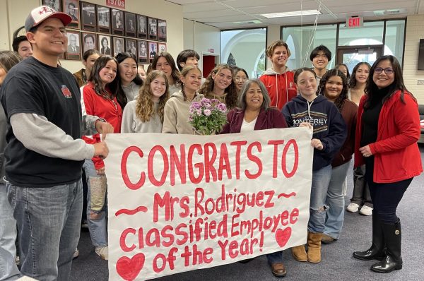 ASB students and Dr. Rubio congratulate Classified Employee of the Year Benigna Rodriguez in the administration office.
