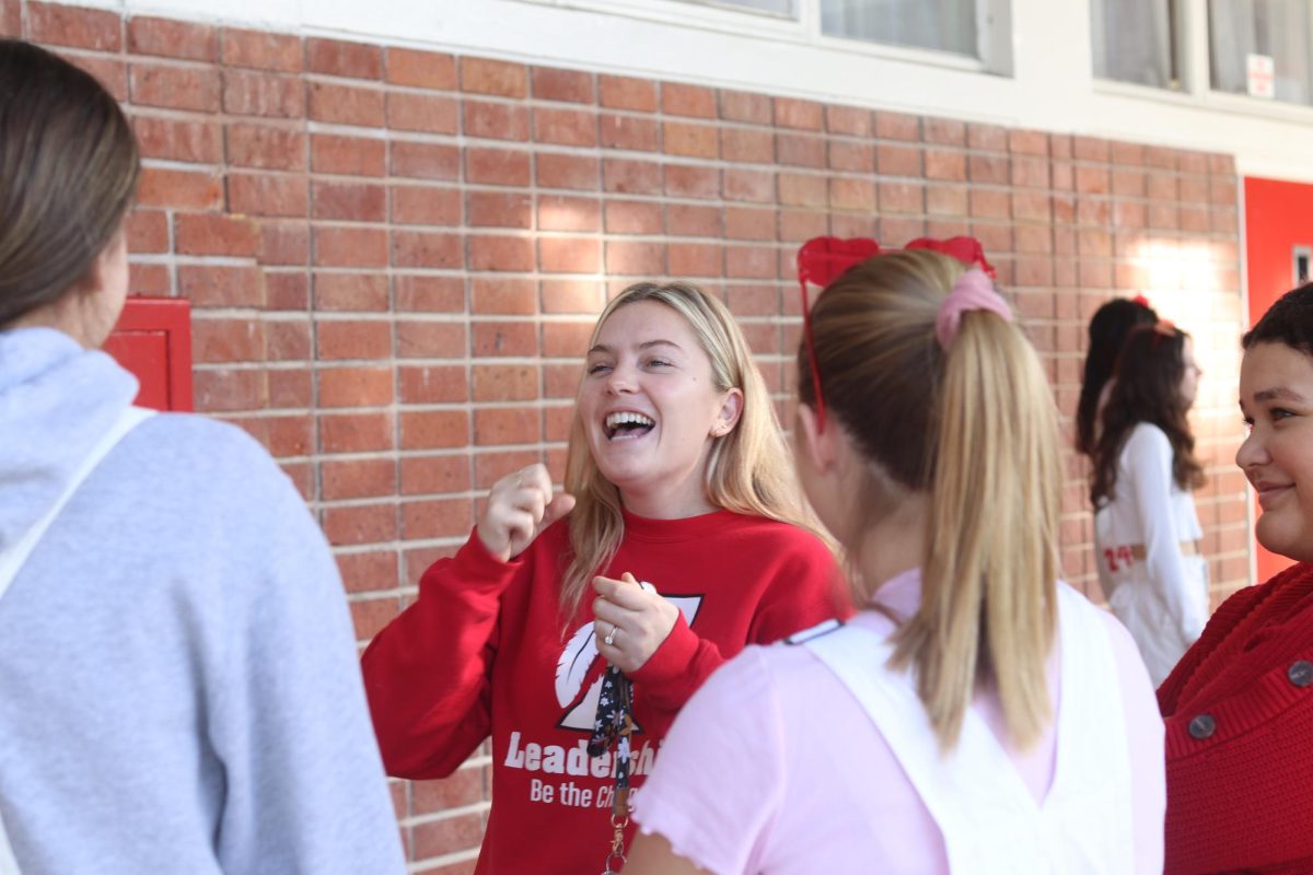 Kerr laughing with ASB members while talking to them. She tries her best to connect with students and show interest in their lives since that was what her best teachers did.