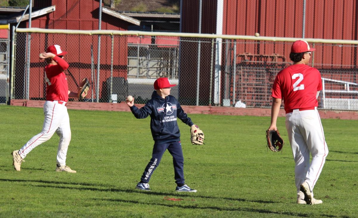 Mikah Carney plays catch with gear given by some of the athletes from the baseball team. Giving gear and playing catch were one of the few ways that the team used to make Carney comfortable and part of the team.