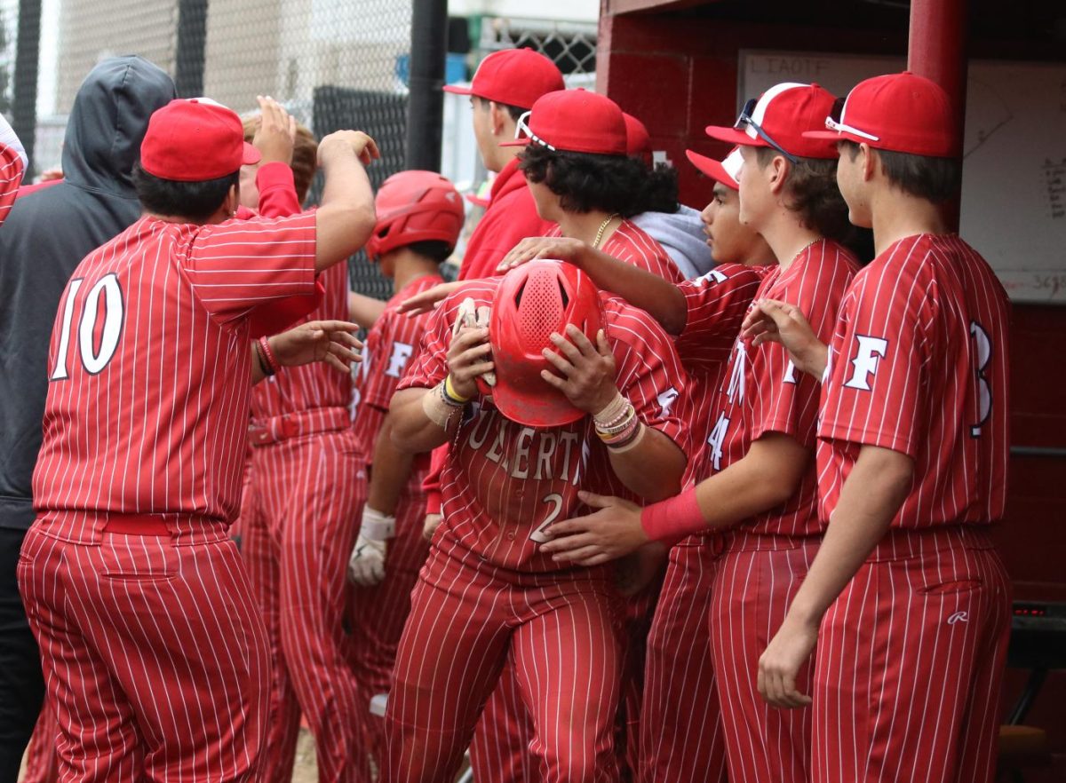 In an April 12 game against Sonora, junior Christian Robinson (center) celebrates after scoring.