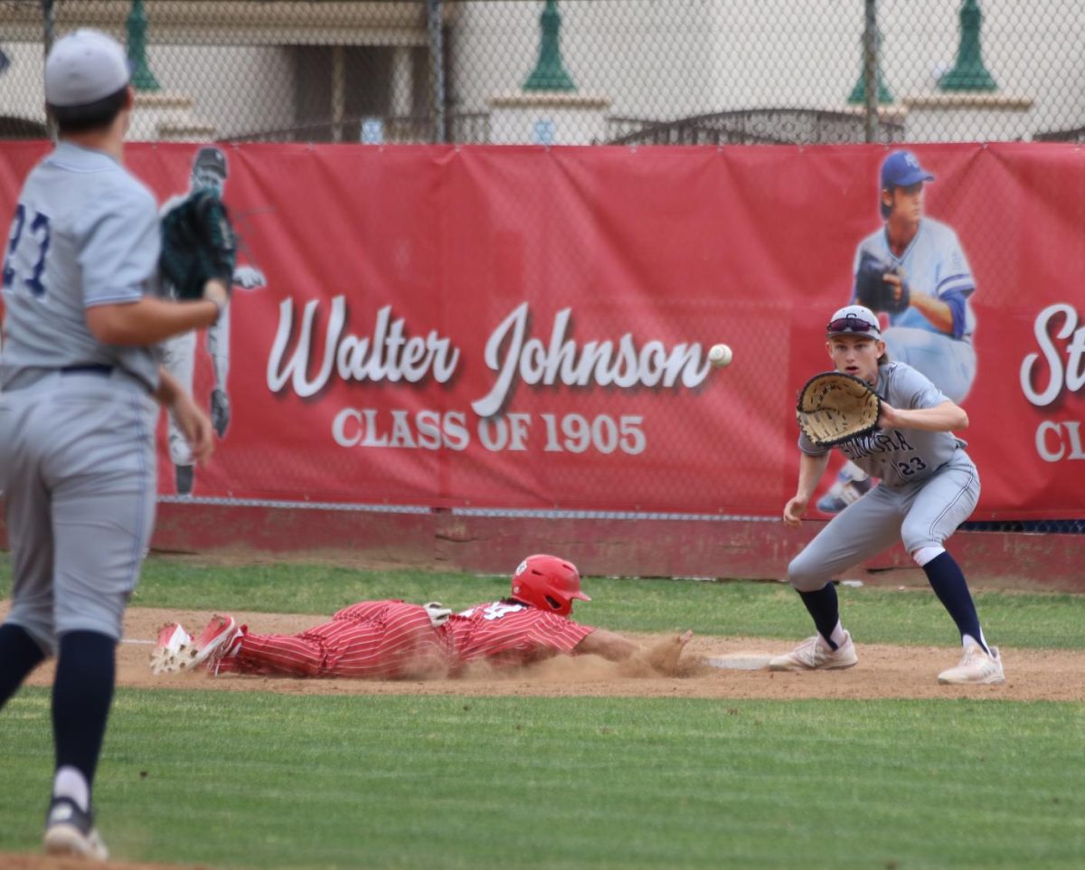 Robinson dives back into the base after Sonora pitcher attempts to pick him off at first.