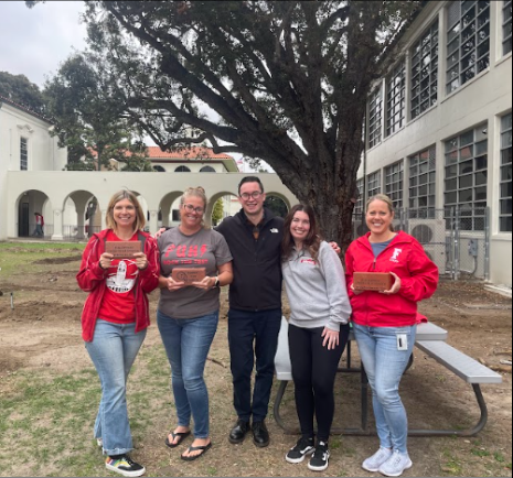 (From left to right) FUHS science teachers Kristen Cruz, Ashley Hill, Tyler Martins, Danica Perez, and Jaimee Rojas stand on the site where OAK commons will be located. Cruz, Hill, and Rojas are holding the legacy bricks that will make up the brick pathway.