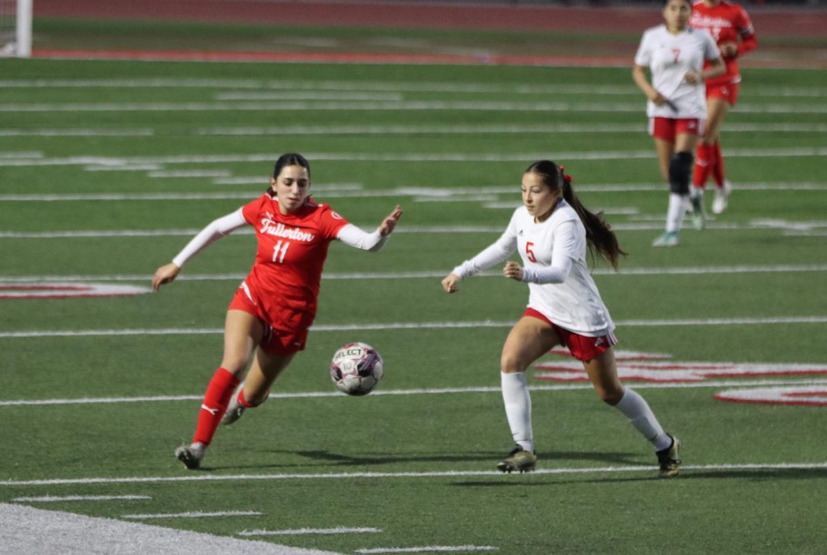 Junior Ava Torres attempts to pass her opponent in the 4-1 win against Santa Ana, cementing their 15-5-3 record. The team plays host to Westminster on Feb. 3, a game that will determine their final standings in league.