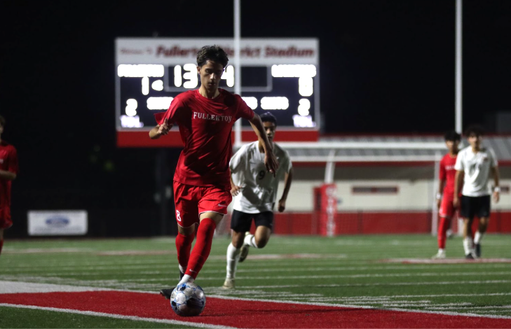 Senior Nicholas Ponce dribbles the ball up right field to score against Los Amigos. The Dec. 6 game resulted in a 3-1 win.