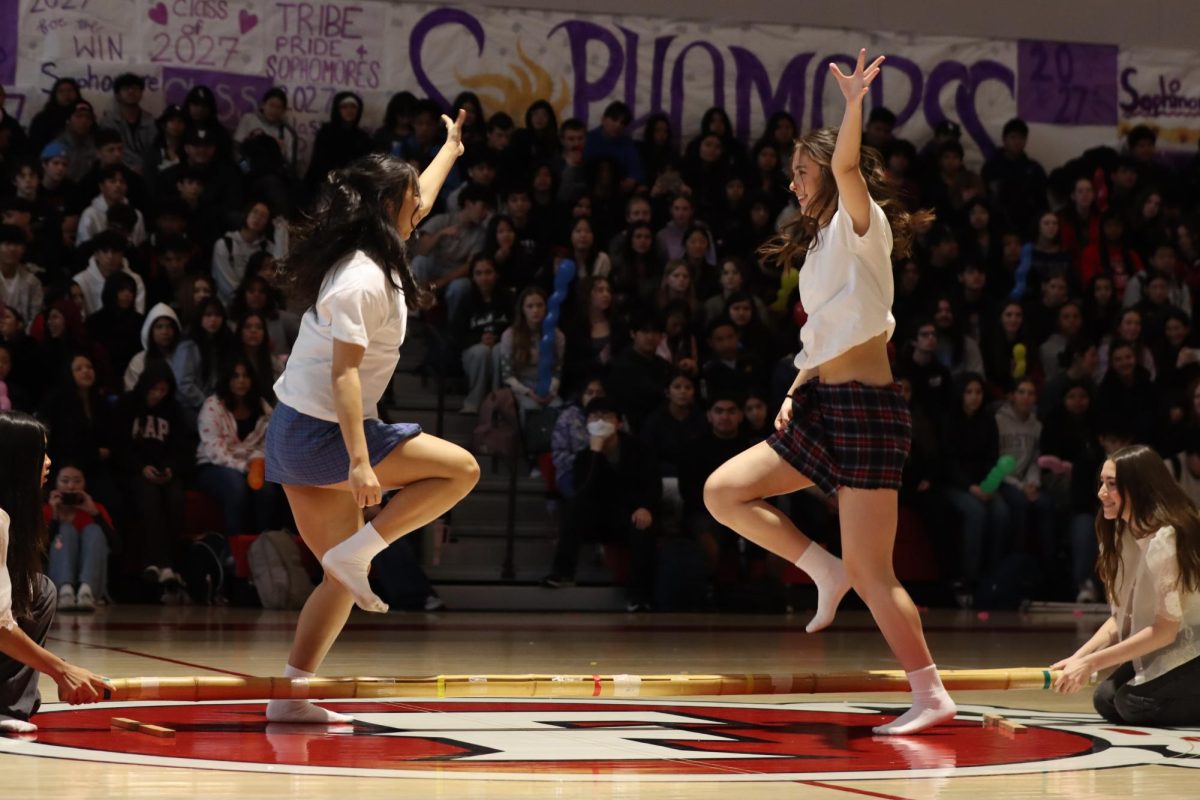 Sophomores Madison Sibal, Emily Kim, Elizabeth Pahl, and Stella Rogido perform a cultural Filipino dance, Tinikling. The sophomores participated in the International Fullerton Fest on Feb. 7 in the gym.