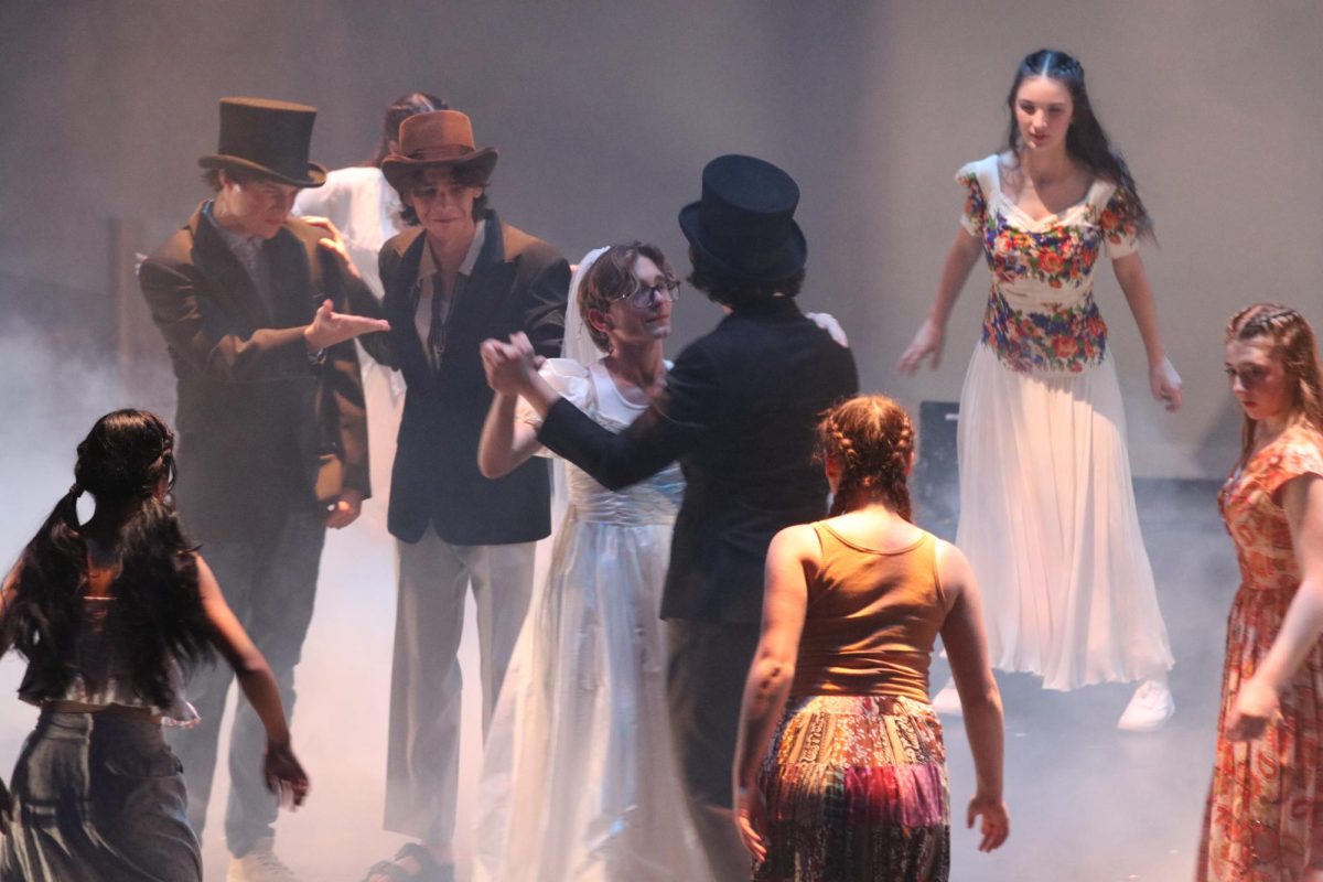 Sky (freshman Anthony Ervin) as a bride dancing with Sophie’s dads (left to right, seniors Andrew Cazares, Mal Shirk, Jonas Baesel) in her nightmare during the beginning of the second act, during the song Under Attack.