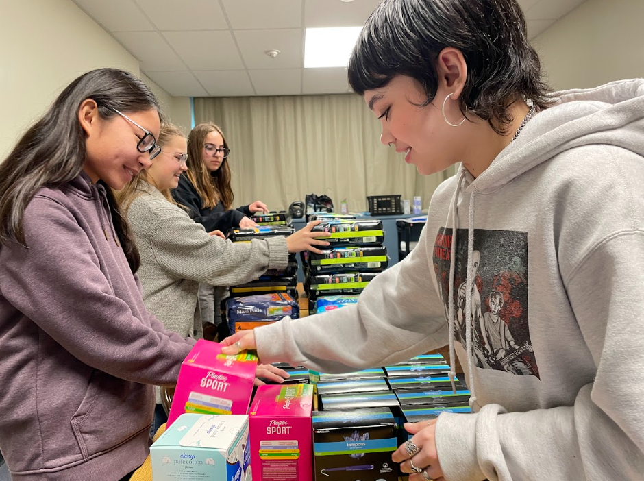 Members of PERIOD Club organize menstrual products. The club also welcomes donations in the form of cash, check, and Tribe Store payments.