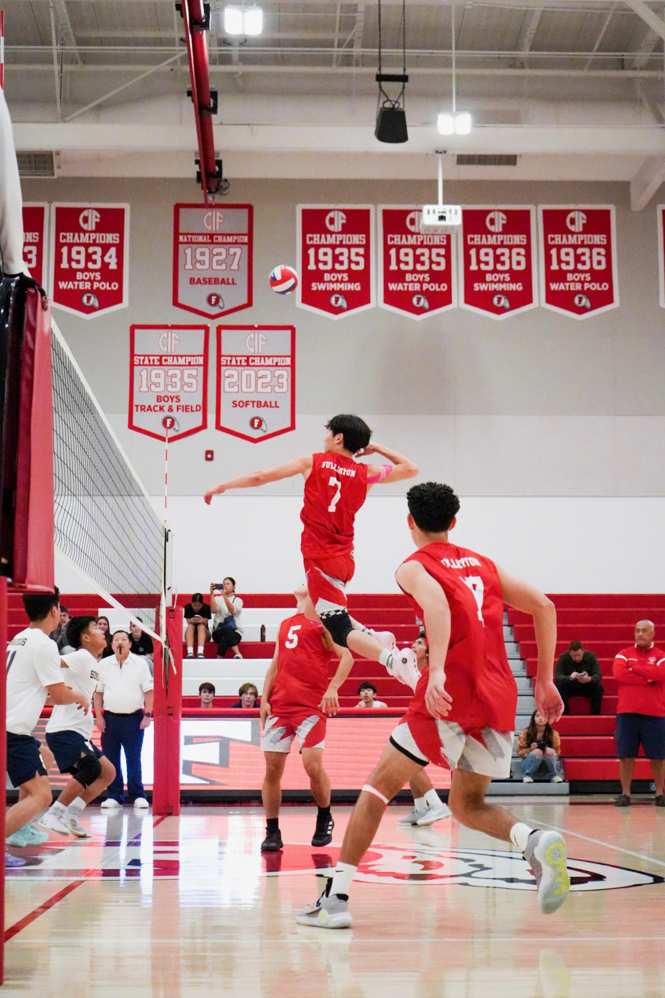 Sophomore Jayden Bae (middle blocker) attempts to score against Sonora on Feb. 20 by spiking the ball after being set up by senior Johnny Vasquez. Photo by Liz Marshall