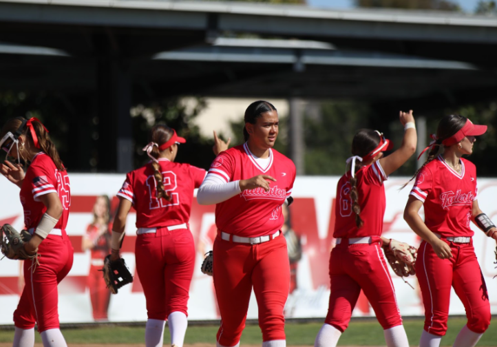 (Pictured from left to right) Sophomores Katelynn Mathews, Ava Flores, and juniors Malaya Majam-Finch, Melia Vera, and Analise Barrios celebrate with a team handshake after Mathews struck out a player in their league match-up against Garden Grove on April 9. 