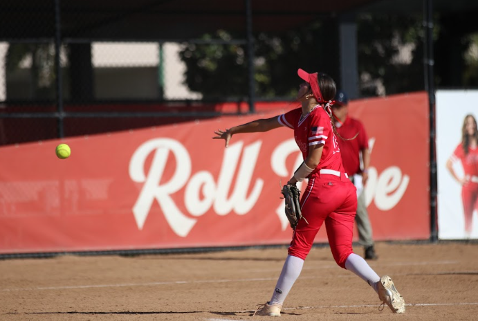 Junior Analise Barrios throws the softball across the field.