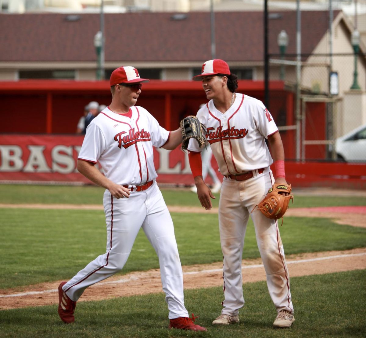 (From left to right) Seniors Wayne Warden and Miguel Velazquez celebrate after scoring a run against Calvary Chapel. Photo by Madison Sibal