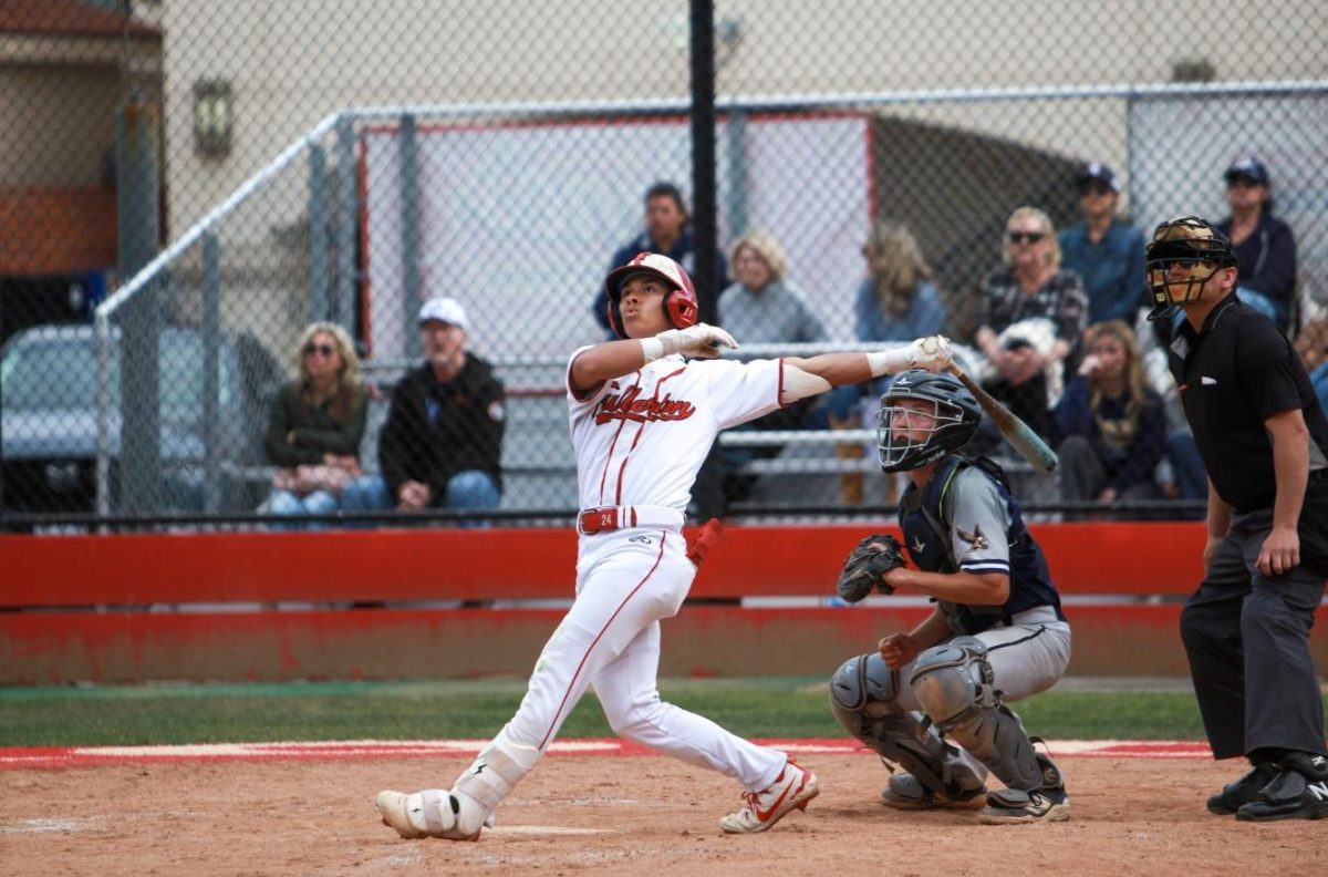 Senior Christian Robinson hits a home run against Calvary Chapel on April 25. Photo by Madison Sibal