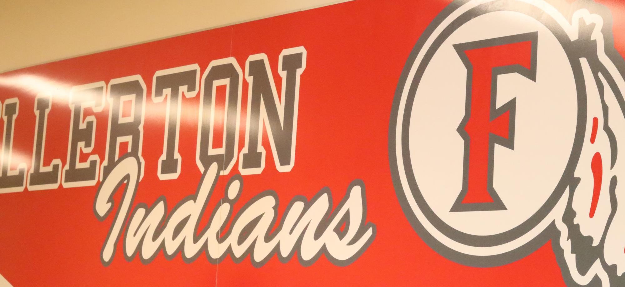 (Background photo) This mural hangs between Room 229 and Room 230, just outside the Tribe Tribune newsroom. Next year the mural will be taken down. The Tribe Tribune will also need a new name as the new law bans the use of the word "tribe" in official school programs.