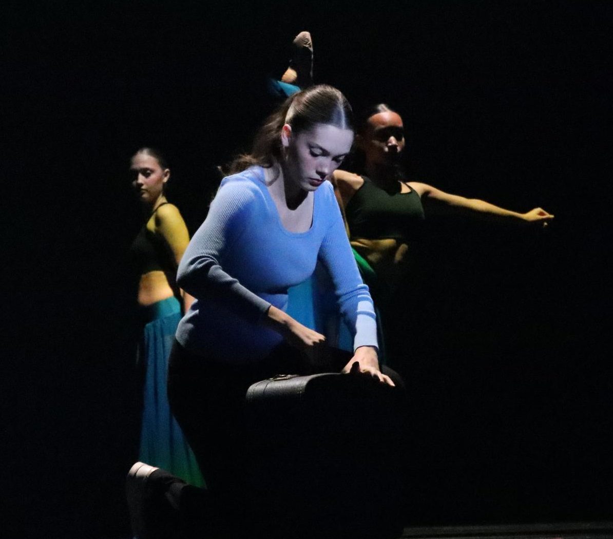 Audience members will see senior choreographer Zoe McLaughlin and her eight dancers tell the story of her mother packing a suitcase and leaving home. McLaughlin chose blue and black lighting to depict emotional “bruising.”