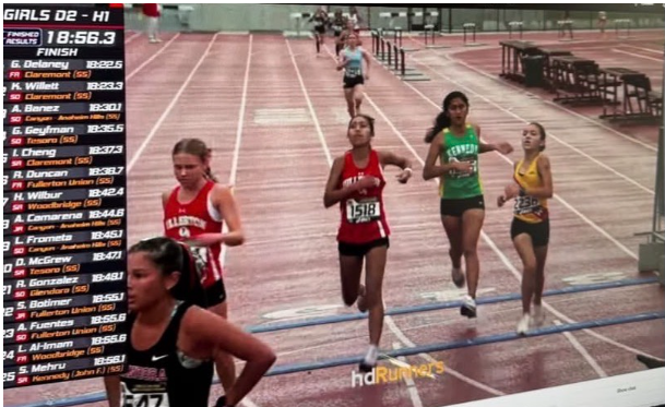 This photo from the CIF Prelims Live Stream on HDRunners captures the moment sophomore Arizona Fuentes's foot stepped over the finish line before Woodbridge's runner (at right in gold shirt). A parent watching from home took a screenshot of the finish before sending it to Coach Krawczyk for official review.