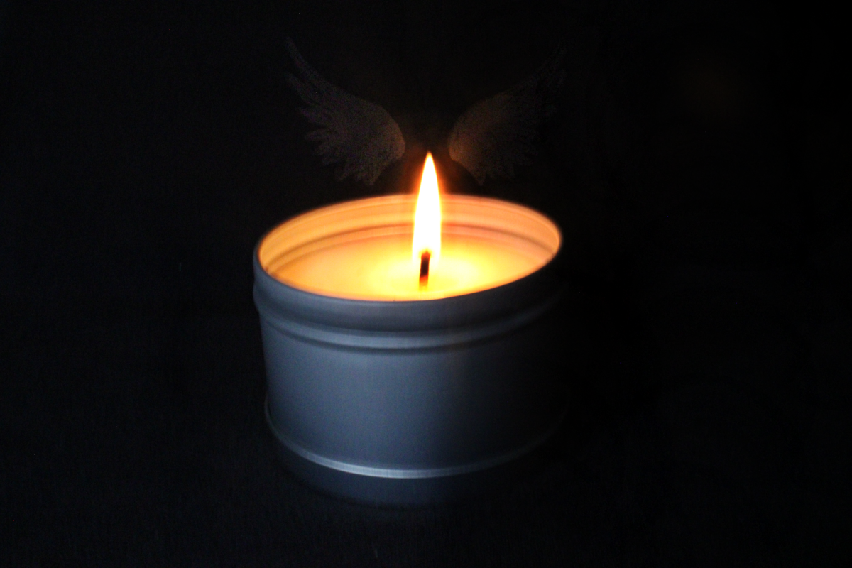 By draping a black t-shirt over her Chromebook, Alvarez created a pitch-black background to make the small candle stand out more. This photo maintains the theme of grief; the dark surrounding the candle is reminiscent of how all-consuming grief can be. 