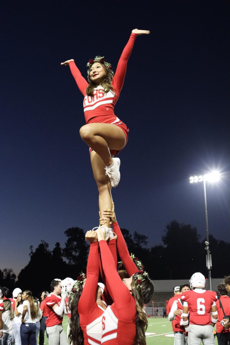 Junior Kaitlyn Kim is lifted during a pyramid.