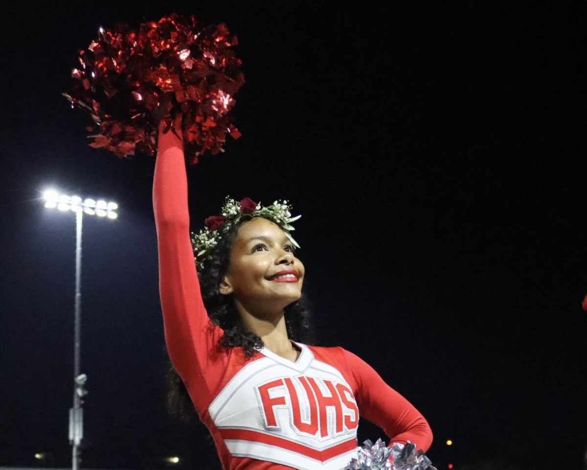 Junior Jaelene Smith cheering at a home football game. 