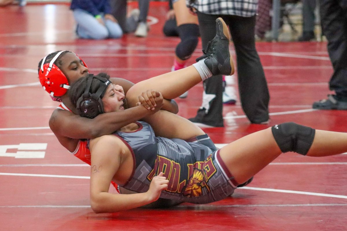 Freshman Jazmine Abanobi locks her opponent up in a cradle at HillCrest High School. Photo by Michael Espinoza

