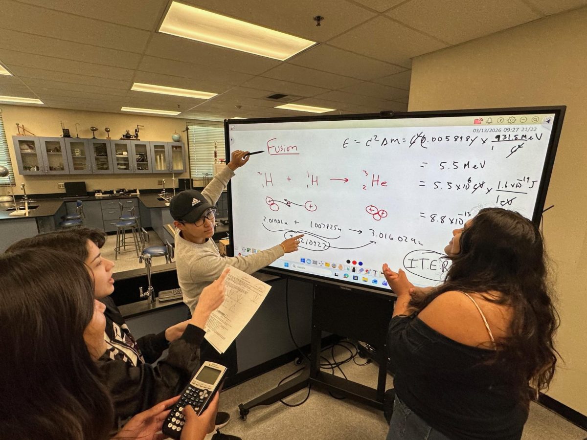 Junior James Ha explains a solution while teammates Katelyn Rodriguez, Abby Guevara, and Alexis Hernandez review calculations during a StellarXplorers practice session. (Photo courtesy of Jim Pitochelli)